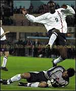 Andy Cole is denied by a lunge from keeper Foto Strakosha